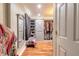 Walk-in closet with hardwood floors, a mirror and gray sliding barn doors for organized, elegant storage at 731 Laurel Bay Cir, New Smyrna Beach, FL 32169