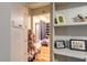 Spacious walk-in closet features shelving units, hardwood floors and plenty of room for organizing clothes and accessories at 731 Laurel Bay Cir, New Smyrna Beach, FL 32169