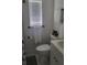 Cozy bathroom with shower and white marble tile flooring and new lighting at 808 Catherine Ave, Daytona Beach, FL 32117
