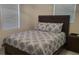 Comfortable bedroom features a wood bed frame with a plush, patterned comforter and matching dresser at 808 Catherine Ave, Daytona Beach, FL 32117