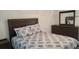 Comfortable bedroom features a wood bed frame with a plush, patterned comforter and matching dresser at 808 Catherine Ave, Daytona Beach, FL 32117