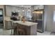 Updated kitchen features an island with seating, stainless steel appliances, and gray cabinets at 808 Catherine Ave, Daytona Beach, FL 32117