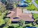 Single-story home with brown roof and surrounding landscaping at 103 Sea St, New Smyrna Beach, FL 32168