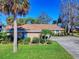 Ranch-style brick home with a brown roof and lush landscaping at 103 Sea St, New Smyrna Beach, FL 32168