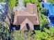 Single-story home with brown roof and surrounding landscaping at 103 Sea St, New Smyrna Beach, FL 32168