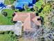 Aerial view of house, driveway, and surrounding landscape at 103 Sea St, New Smyrna Beach, FL 32168