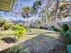 Landscaped backyard with lush greenery and wooden fence at 103 Sea St, New Smyrna Beach, FL 32168