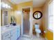 Bathroom with shower, toilet, vanity, and large mirror at 103 Sea St, New Smyrna Beach, FL 32168