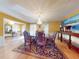 Formal dining room with hardwood floors, chandelier and large artwork at 103 Sea St, New Smyrna Beach, FL 32168