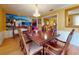 Formal dining room with wood table and chairs, hardwood floors, and large artwork at 103 Sea St, New Smyrna Beach, FL 32168