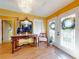 Bright entryway with hardwood floors, ornate console table, and chandelier at 103 Sea St, New Smyrna Beach, FL 32168