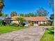 Brick home with a well-manicured lawn and driveway at 103 Sea St, New Smyrna Beach, FL 32168