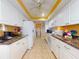 Galley style kitchen with white cabinets and granite countertops at 103 Sea St, New Smyrna Beach, FL 32168