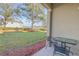 Small patio with table and chairs, overlooking a grassy backyard at 104 Kelly Thomas Way, Daytona Beach, FL 32124