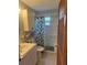 Clean bathroom with a shower/tub combo and floral shower curtain at 109 Western Ave, Edgewater, FL 32132