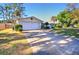 White brick home with a driveway and large grassy yard at 1120 Marcel St, New Smyrna Beach, FL 32168