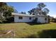 Rear view of the house showcasing a large backyard at 1120 Marcel St, New Smyrna Beach, FL 32168