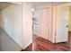 Shows a hallway with wood floors and a view into the kitchen at 1120 Marcel St, New Smyrna Beach, FL 32168