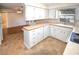 Kitchen with white cabinets, tile flooring, and a window at 1120 Marcel St, New Smyrna Beach, FL 32168