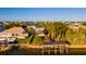 Waterfront home aerial view, showcasing boat lift and mature trees at 1324 N Peninsula Ave, New Smyrna Beach, FL 32169