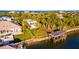 Aerial view of waterfront property with boat lift and lush landscaping at 1324 N Peninsula Ave, New Smyrna Beach, FL 32169