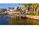 Waterfront property featuring a wooden boat lift and dock at 1324 N Peninsula Ave, New Smyrna Beach, FL 32169