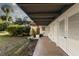 Covered patio with white doors and lush landscaping at 1324 N Peninsula Ave, New Smyrna Beach, FL 32169