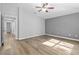 Large bedroom with wood-look floors and access to hallway at 137 Grey Widgeon Ct, Daytona Beach, FL 32119