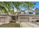 Front view of a two-story townhome with a garage and walkway at 137 Grey Widgeon Ct, Daytona Beach, FL 32119