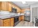 Modern kitchen with stainless steel appliances and wood cabinets at 137 Grey Widgeon Ct, Daytona Beach, FL 32119