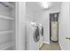 Laundry room with washer, dryer, and shelving at 137 Grey Widgeon Ct, Daytona Beach, FL 32119