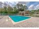 Community pool with lounge chairs and a paved patio at 137 Grey Widgeon Ct, Daytona Beach, FL 32119