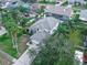 Aerial view of house and surrounding landscape, including palm trees at 1381 S Wembley Cir, Port Orange, FL 32128