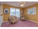 Cozy sitting area with two armchairs and large window at 1381 S Wembley Cir, Port Orange, FL 32128