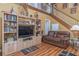 Living room with built-in entertainment center and hardwood floors at 1381 S Wembley Cir, Port Orange, FL 32128