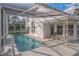 Relaxing pool area with screened enclosure and patio furniture at 1381 S Wembley Cir, Port Orange, FL 32128