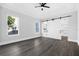 Spacious bedroom with wood-look floors and barn door at 142 Sandpiper Ridge Dr, Ormond Beach, FL 32176