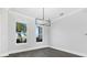 Bright dining room with gray floors and modern chandelier at 142 Sandpiper Ridge Dr, Ormond Beach, FL 32176