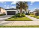 Modern two-story house with black garage door and lush landscaping at 142 Sandpiper Ridge Dr, Ormond Beach, FL 32176