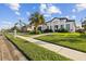 New construction home with palm trees and a manicured lawn at 142 Sandpiper Ridge Dr, Ormond Beach, FL 32176