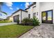 Contemporary home with dark gray garage door and landscaping at 142 Sandpiper Ridge Dr, Ormond Beach, FL 32176