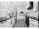 Modern kitchen with white cabinets, black countertops, and stainless steel appliances at 142 Sandpiper Ridge Dr, Ormond Beach, FL 32176