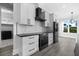 Modern kitchen with white cabinets, black countertops, and stainless steel appliances at 142 Sandpiper Ridge Dr, Ormond Beach, FL 32176