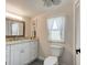 Updated bathroom with white vanity, granite countertop, and tiled floor at 144 Ellison Ave, New Smyrna Beach, FL 32168