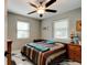 Comfortable bedroom with a bed, dresser, and ceiling fan at 144 Ellison Ave, New Smyrna Beach, FL 32168