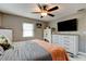 Bright bedroom featuring a large bed, dresser, and ceiling fan at 144 Ellison Ave, New Smyrna Beach, FL 32168