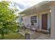 Inviting front porch with white wicker chairs and decorative accents at 144 Ellison Ave, New Smyrna Beach, FL 32168