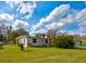 Charming ranch home with a well-manicured lawn and lush landscaping at 144 Ellison Ave, New Smyrna Beach, FL 32168