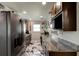 Modern kitchen with dark cabinetry and granite countertops at 144 Ellison Ave, New Smyrna Beach, FL 32168