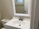 Bathroom features vanity with sink and mirror at 1500 Wildrose Ln, Daytona Beach, FL 32117